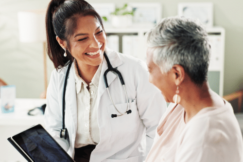 ENT talking to a patient and smiling